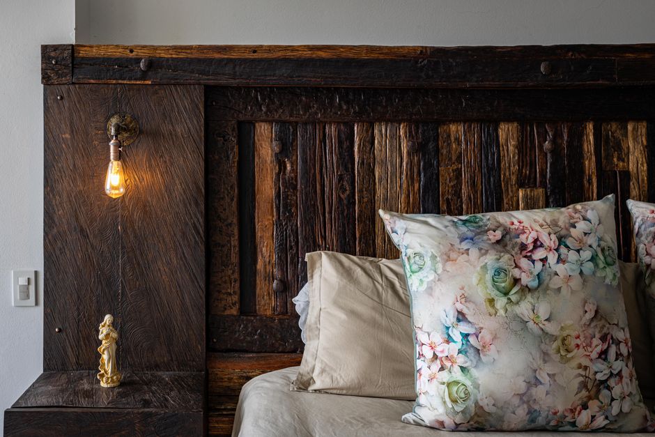 Tête de lit bois massif chêne naturel dans une chambre cosy avec linge blanc, exemple de style rustique chic